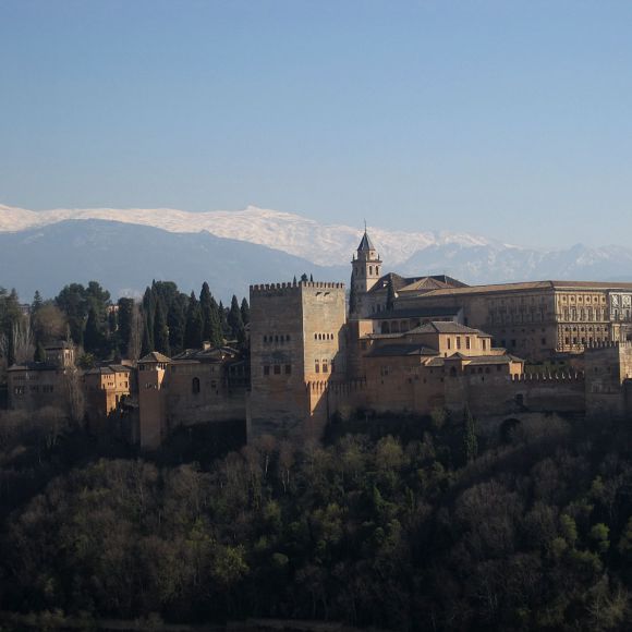 The Alhambra, the stronghold and palace of the moorish emirs in Granada. In the background: the snowy mountains of the Sierra Nevada.